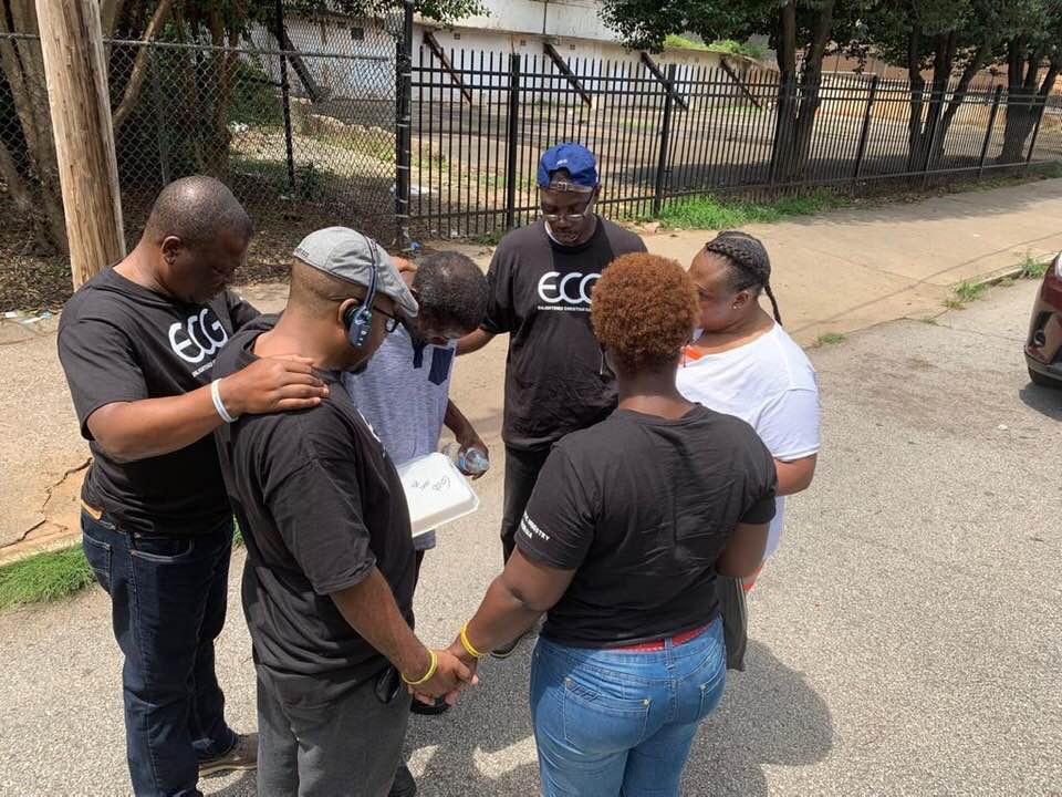 Leaders at ECG Alpharetta praying for peoplee